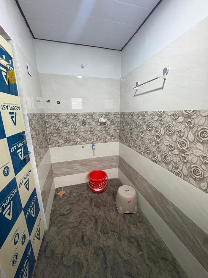 Tiled bathing area with shower at the Nandai Gate stay.