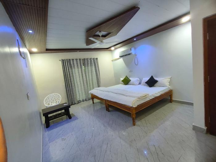 Guest room with white bedding and a curtained sliding door at the Nandai Gate stay.