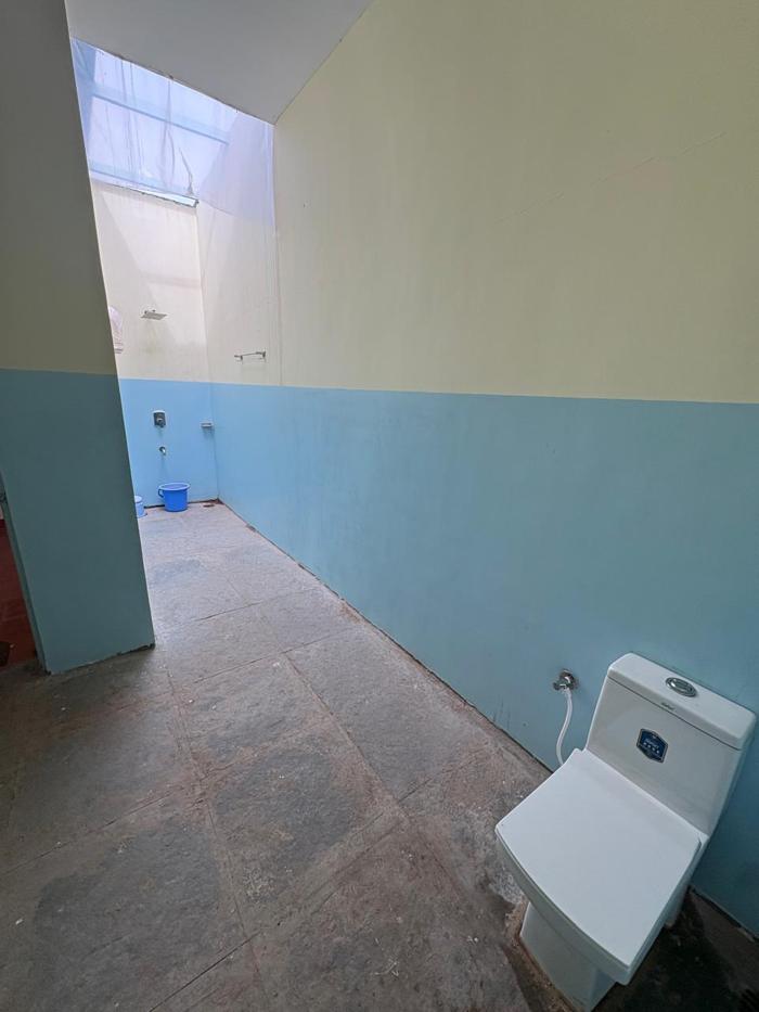 Attached bathroom leading to the shower area at the Bhavankhori Gate stay.